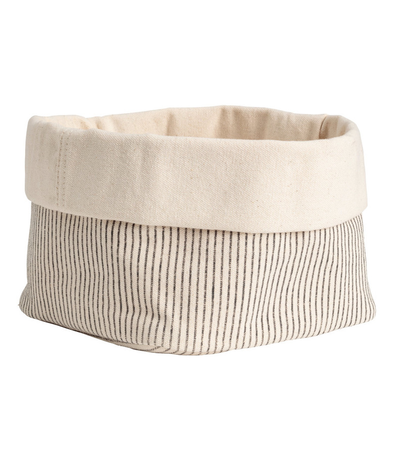 Beige canvas storage basket with black pin stripes