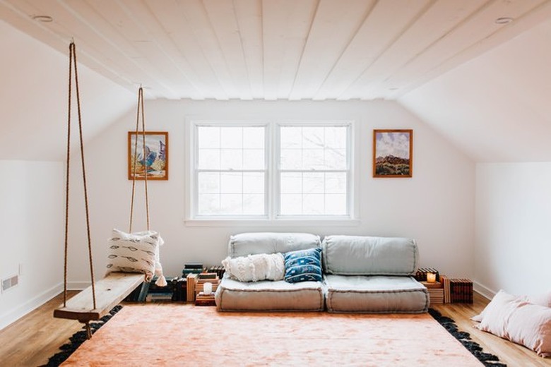 cozy attic with floor seating and swinging rope bench