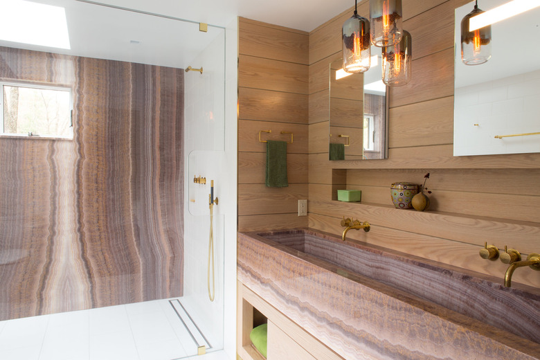 Modern bathroom sink in pink onyx matching shower accent wall