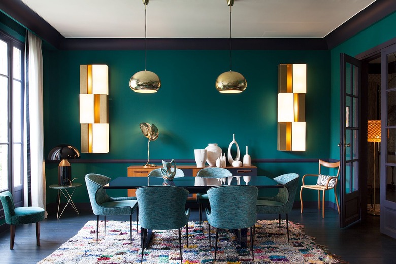 teal dining room with gold accents