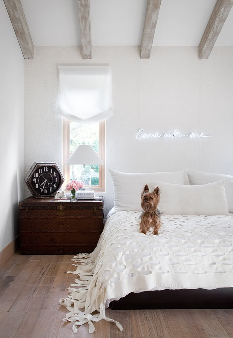 neon sign in rustic white bedroom