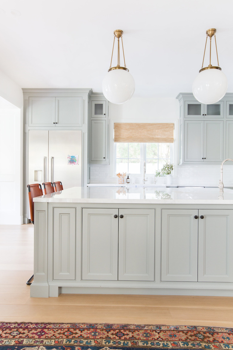 Gray kitchen island storage with cabinets and marble countertop