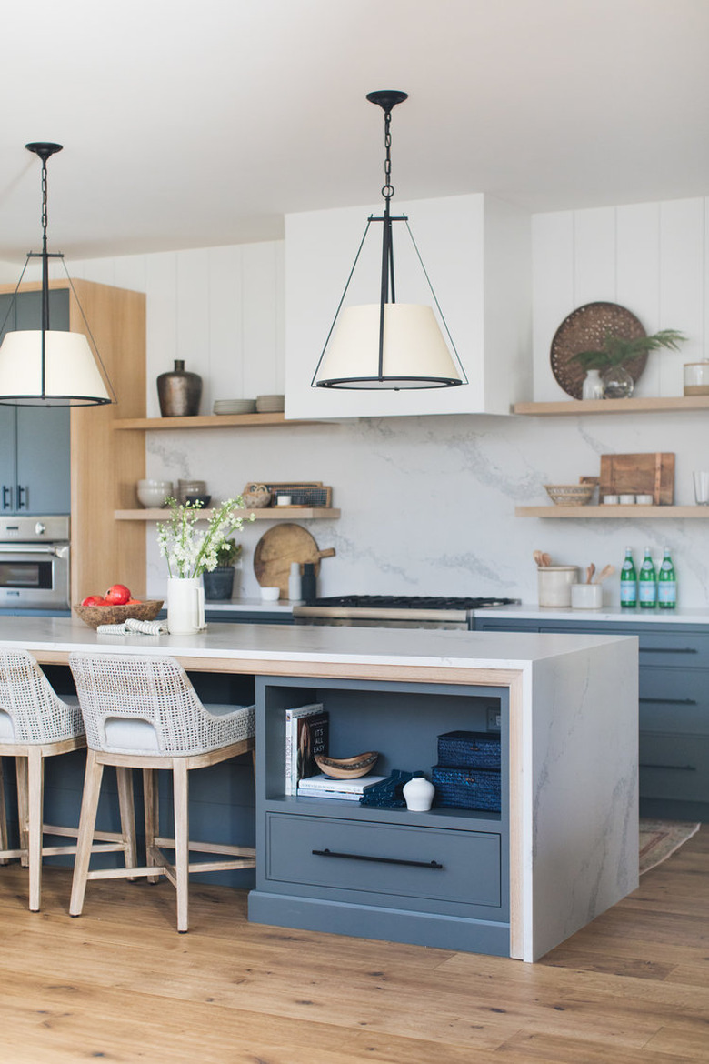 Blue kitchen island storage with marble waterfall countertop