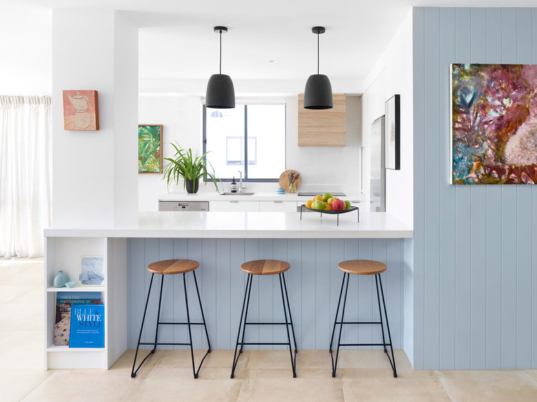 rental kitchen lighting with black pendants over white countertop