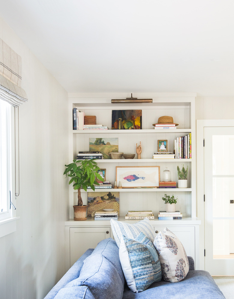 living room shelving idea in white space with blue sofa