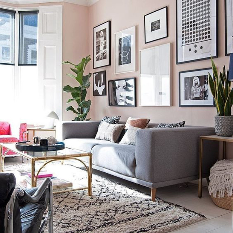 pink living room with black and white gallery wall