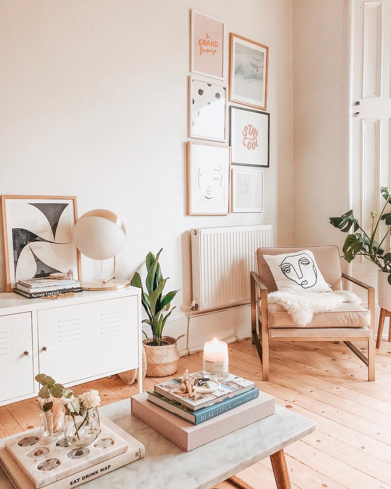 living room with pink lounge chair and artwork