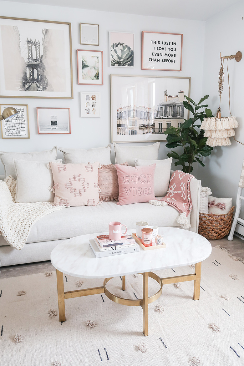 living room with pink pillows on sofa and pink blanket