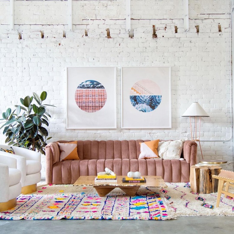 living room with pink channel-tufted sofa and pink accents