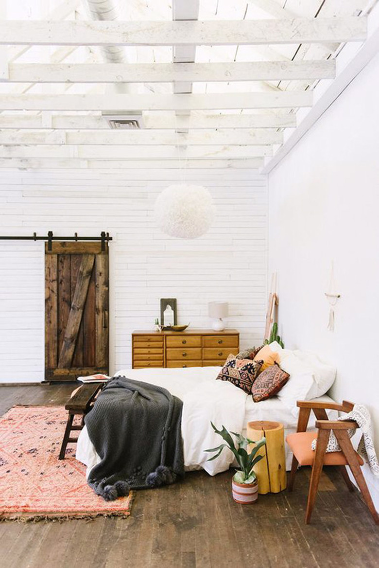 Bohemian bedroom with white-painted ceiling beams