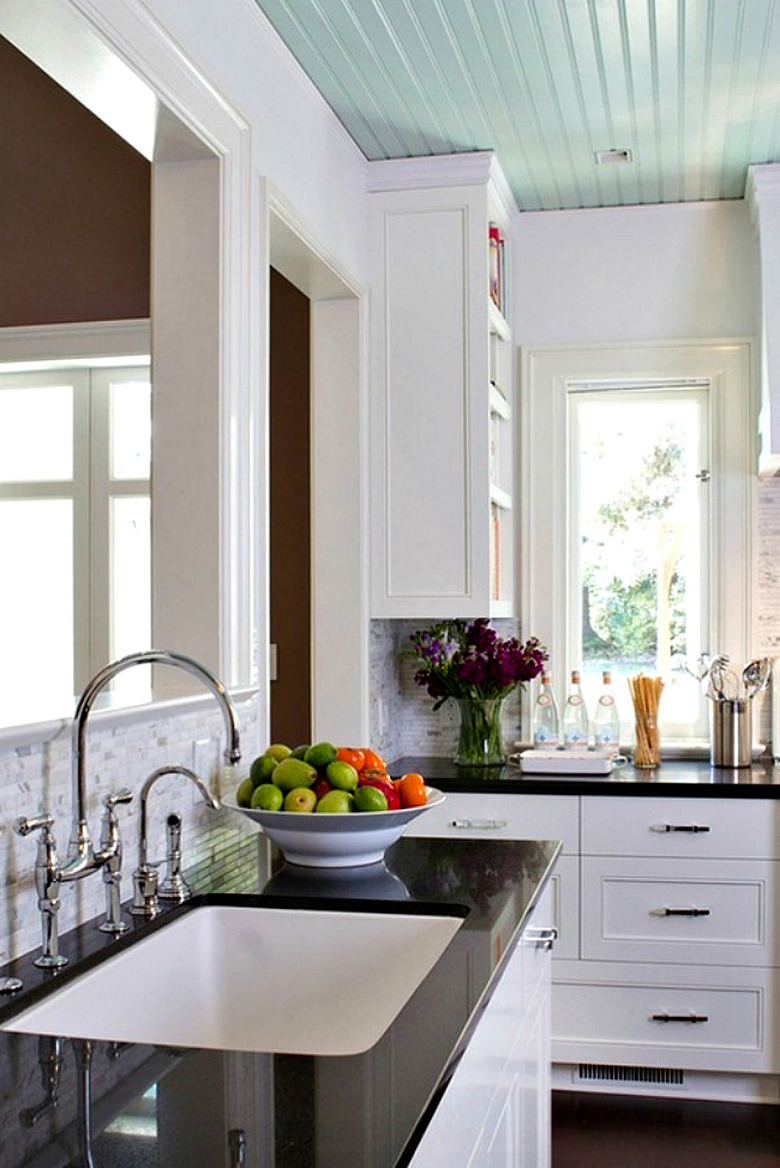 Black and white kitchen with pale turquoise ceiling