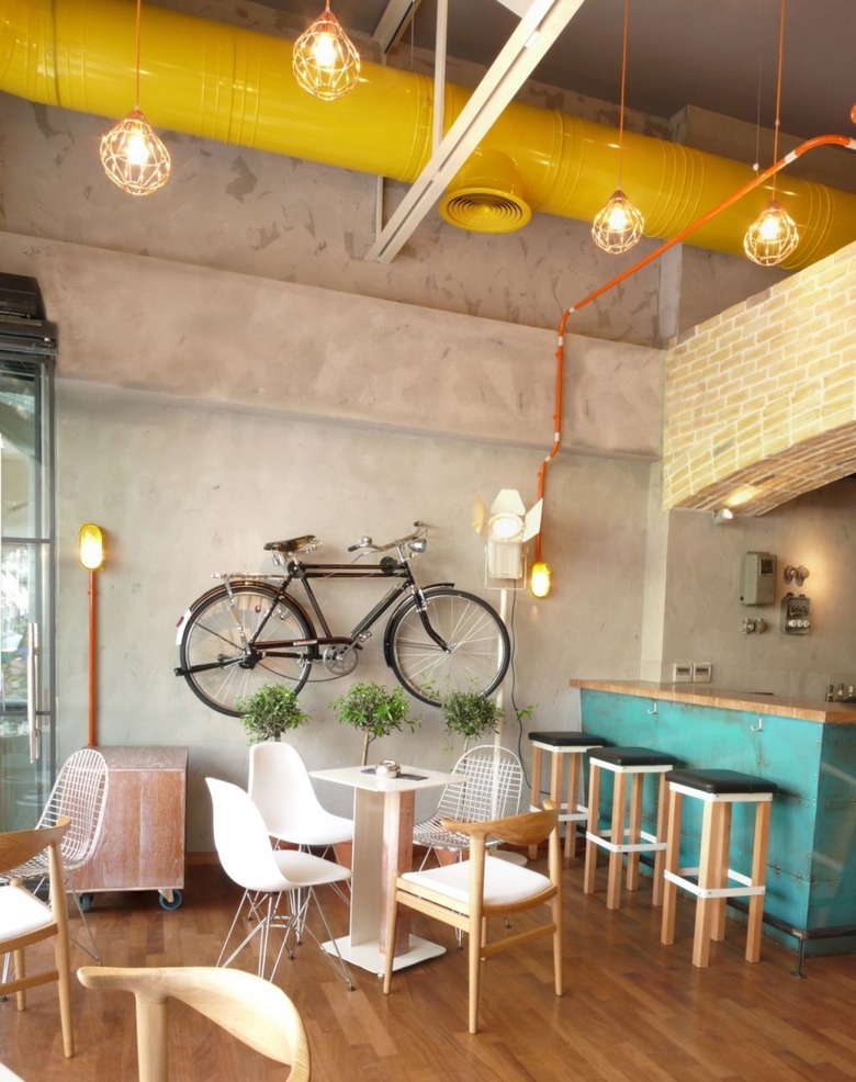 Urban living room with yellow painted pipe in ceiling