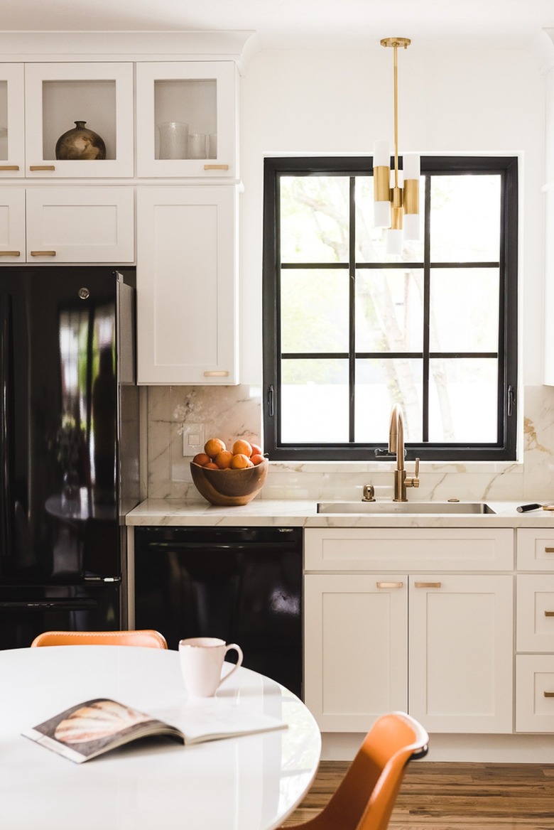 black and white kitchen with modern light fixture