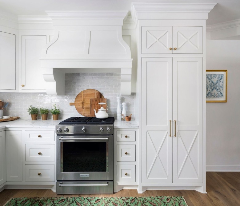 white cabinets in traditional kitchen with x-shaped details