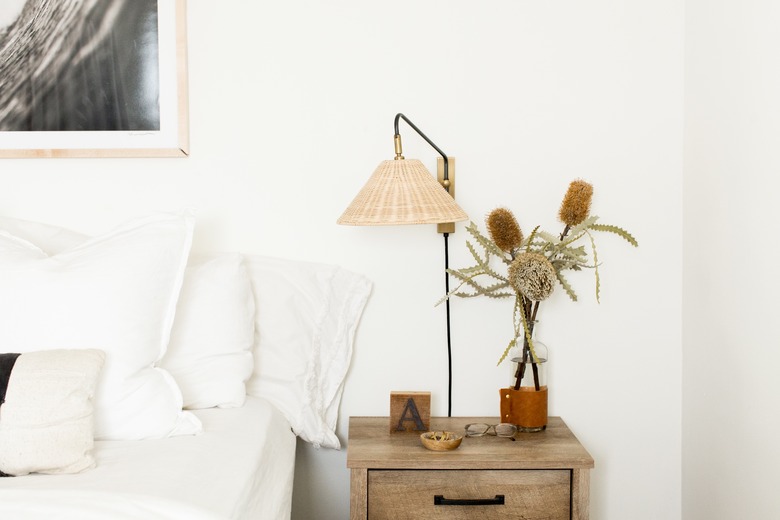 Guest bedroom with bed, side table, and lamp