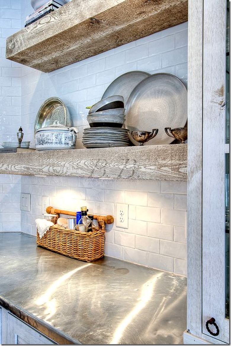 Zinc countertop and raw wood shelves with subway tile