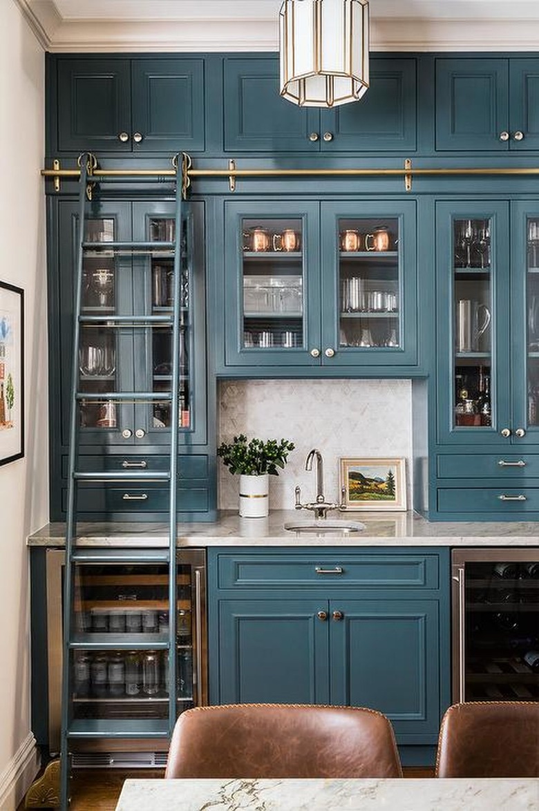 glossy blue kitchen butlers pantry with library ladder