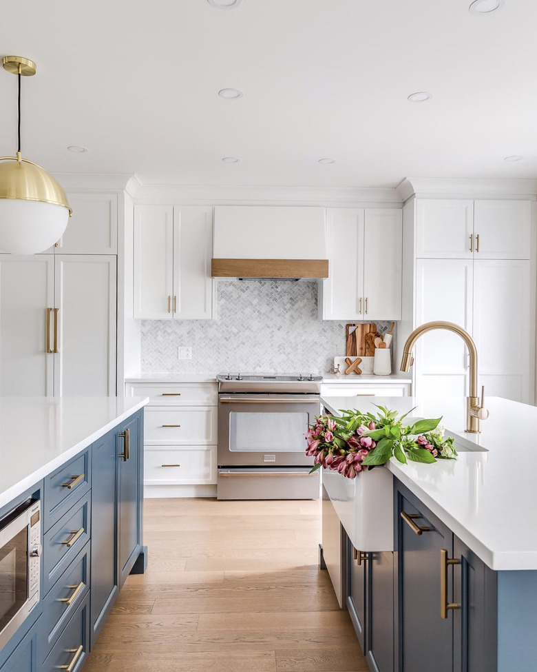 bright white kitchen with blue islands