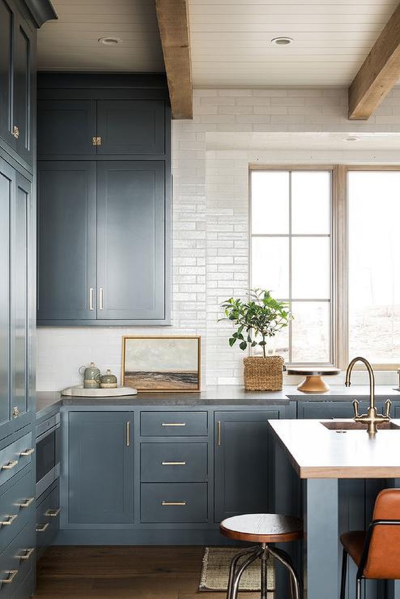 blue inset kitchen cabinets and wooden beams