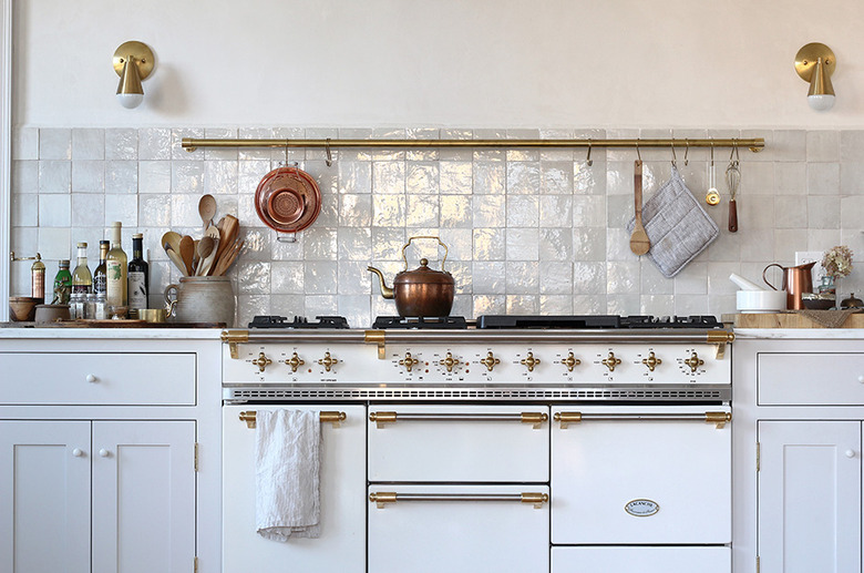 White kitchen design with tile backsplash and French style stove