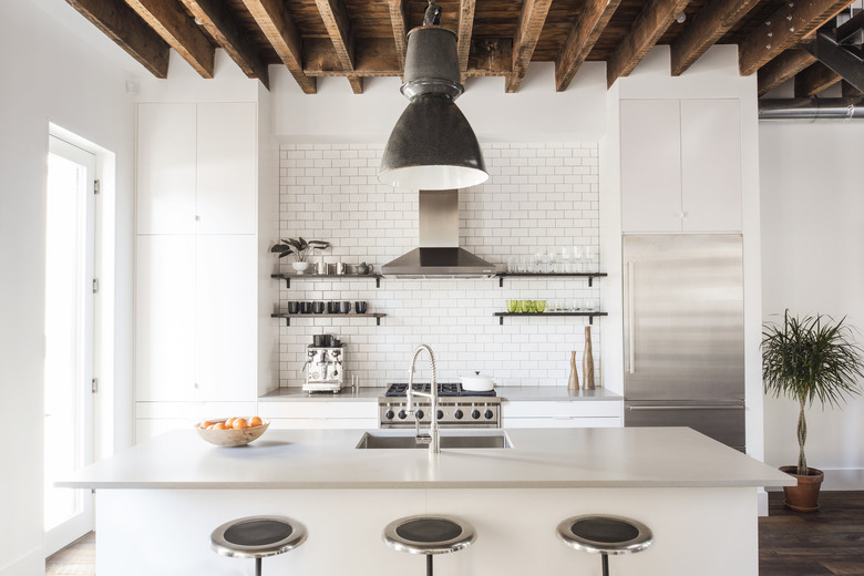 White kitchen design with wood beams