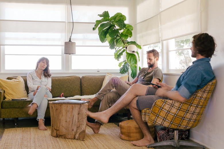 Three friends sitting in a living room