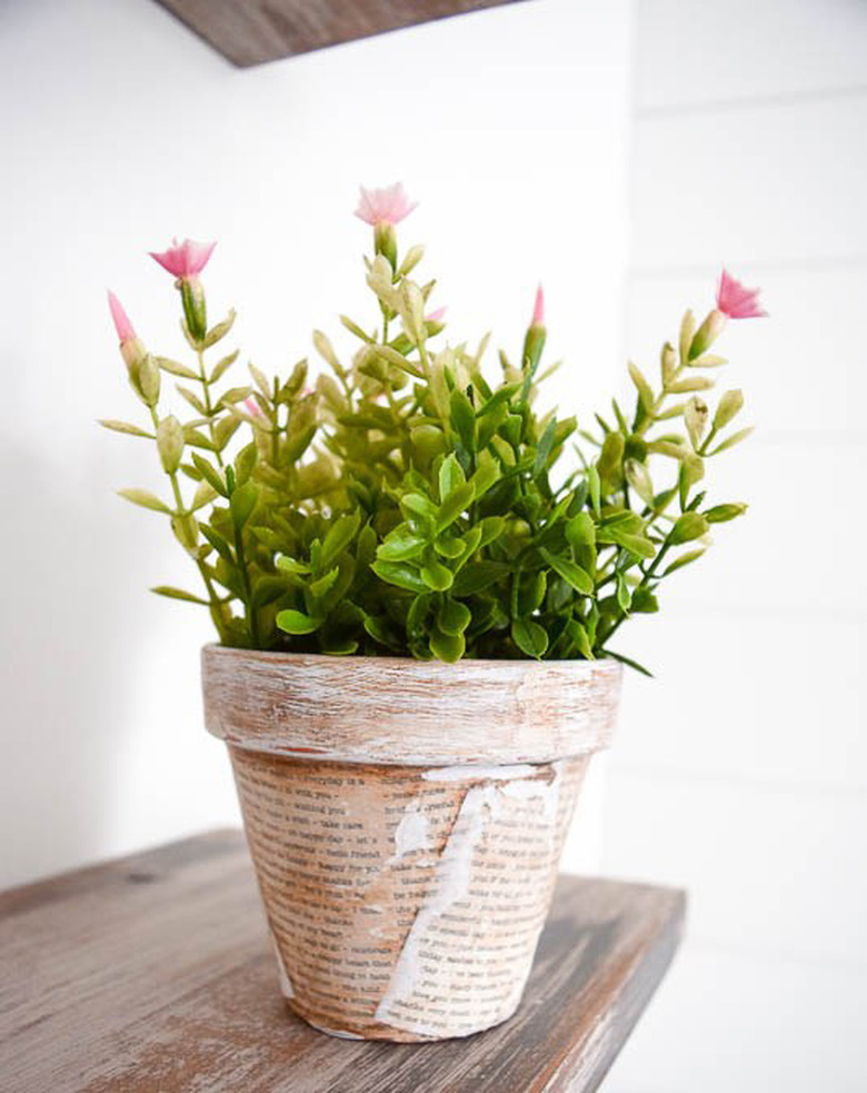 terra-cotta planter covered in book pages