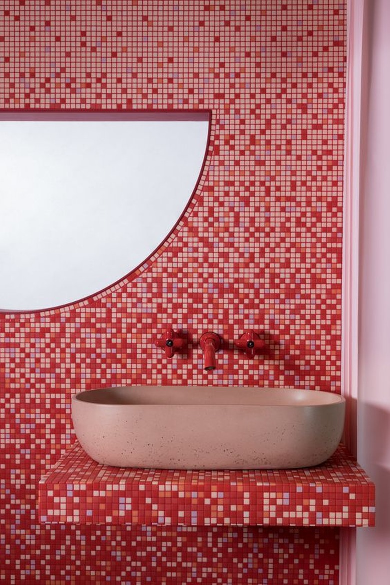 red and pink bathroom with mosaic tiles and tile countertop