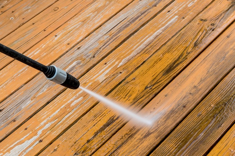 Pressure washing a deck.