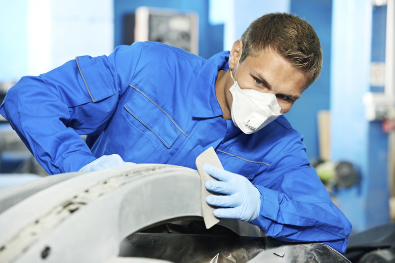 auto mechanic polishing car