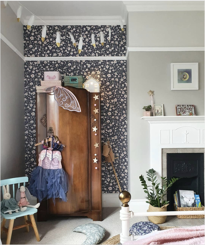 Vintage wardrobe in girls bedroom for toy storage