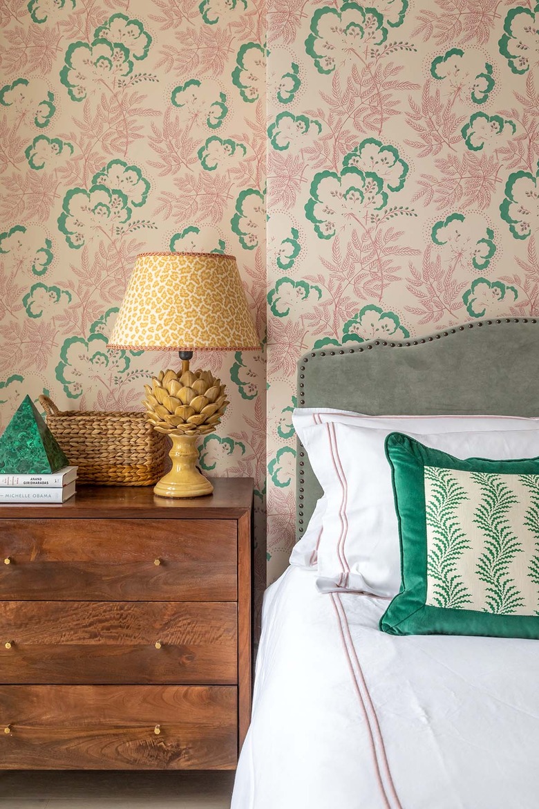 traditional bedroom color schemes with pink and green wallpaper and wood nightstand