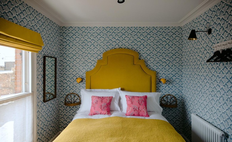 yellow bed in traditional bedroom color schemes with blue wallpaper