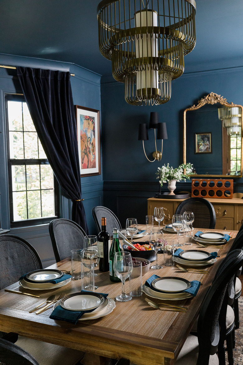 Navy blue dining room with brass traditional dining room lighting