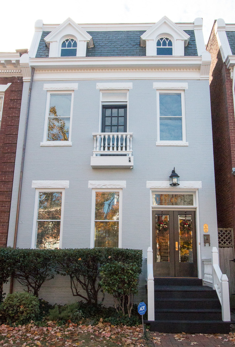 traditional front doors with glass panes in blue townhouse