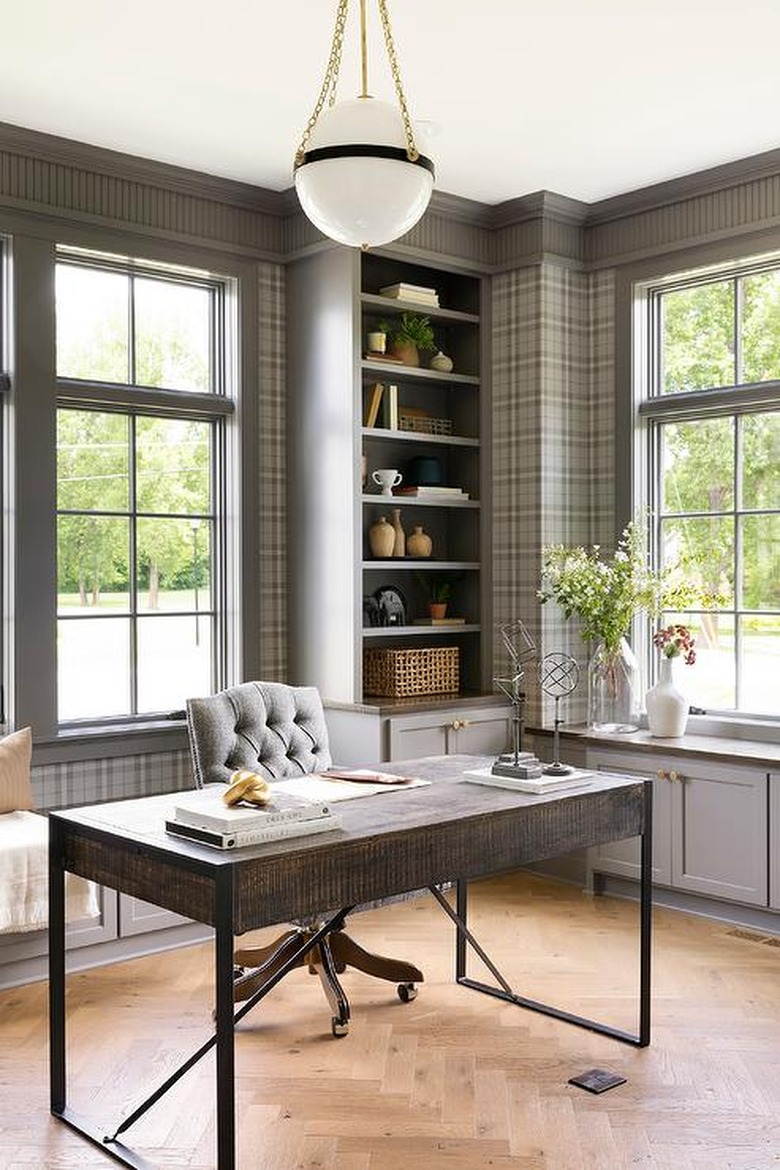 traditional home office with plaid wallpaper and tufted swivel desk chair