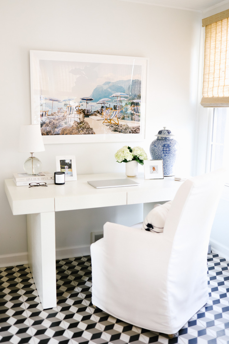 traditional home office with slipcovered chair and oversized photo art