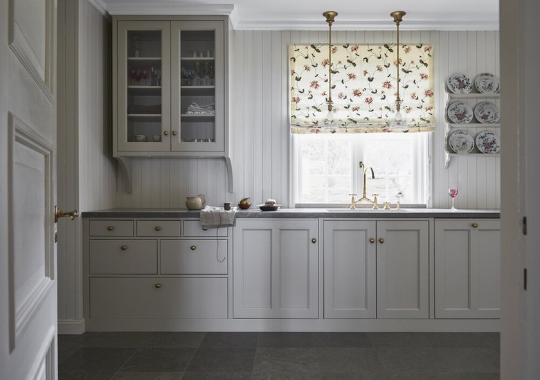 traditional kitchen with beadboard wall paneling and Roman shade window covering