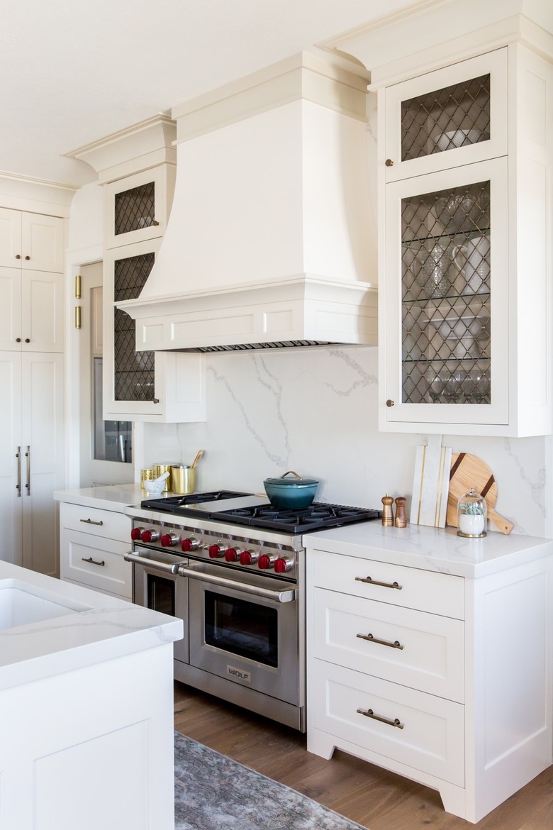 white traditional kitchen with large decorative range hood