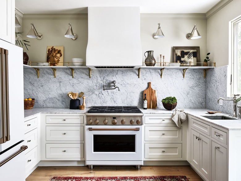 traditional kitchen with marble backsplash and open shelving for art