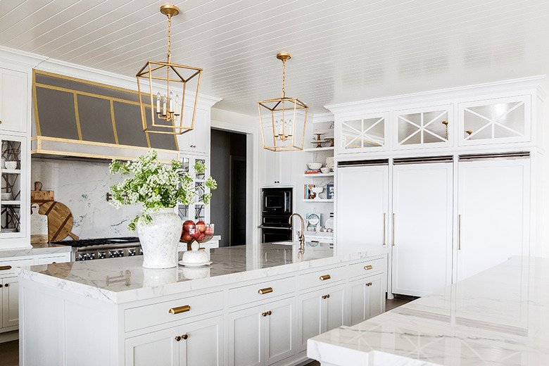 Traditional kitchen island with marble counter and indoor plants