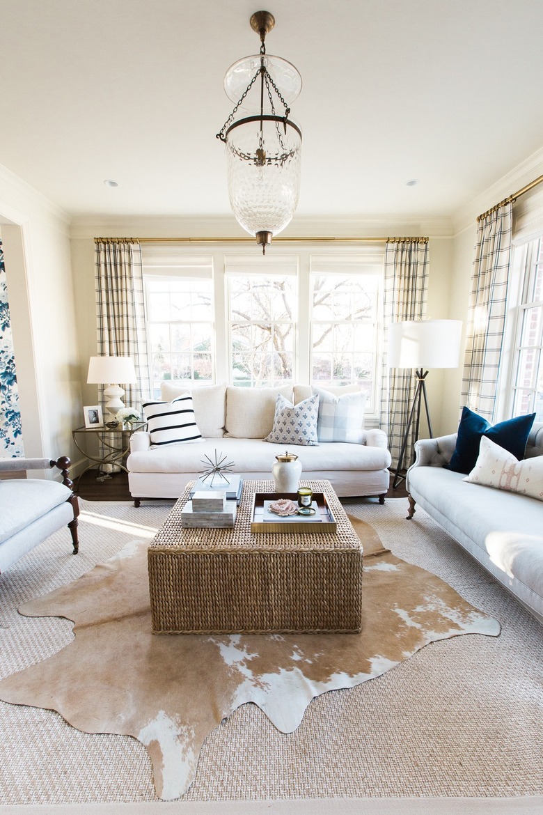 cream traditional living room with sofas and woven coffee table