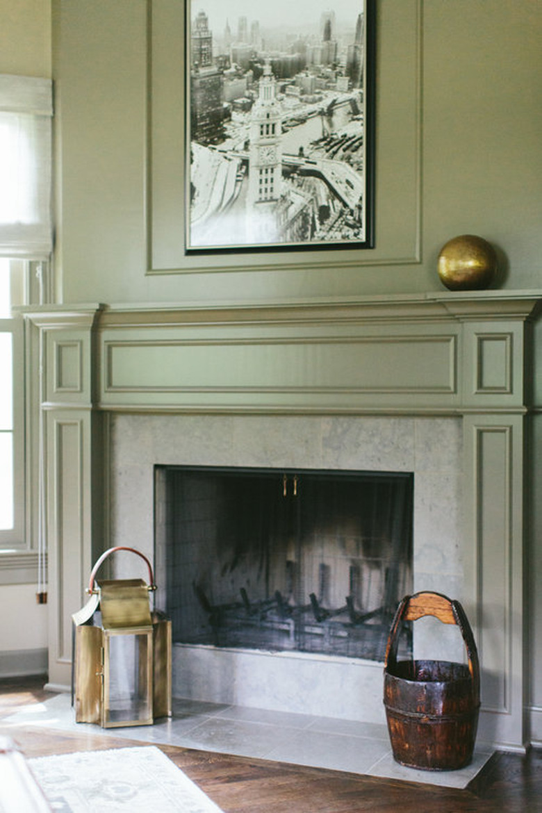 traditional mantel decor with brass gloce and crown molding