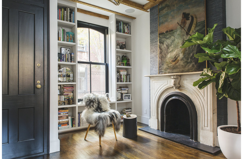 traditional mantel decor with large painting and black door