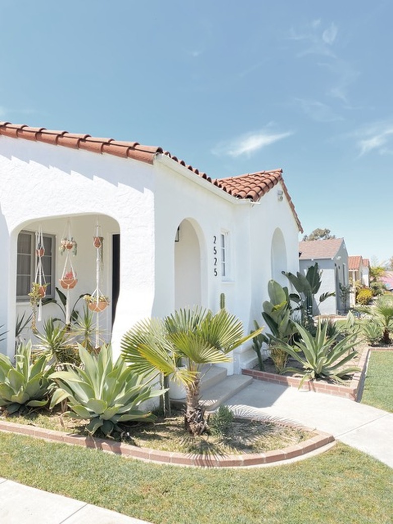 white traditional stucco homes with red roof and desert landscaping