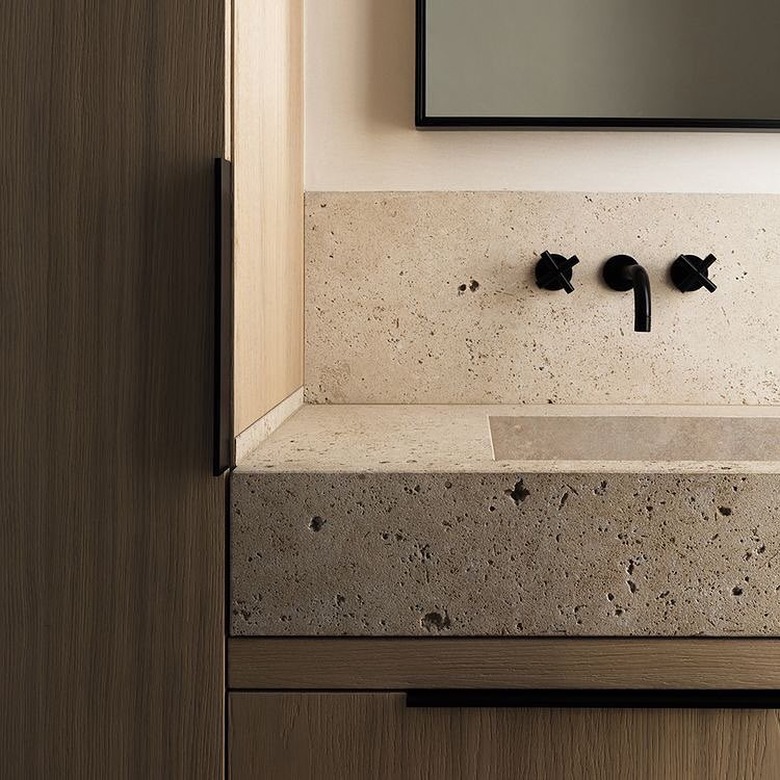 Travertine sink and backsplash in modern bathroom