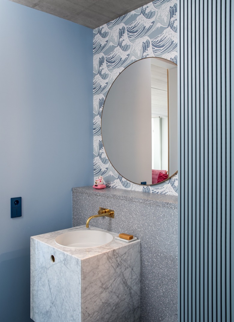 sky blue bathroom color  with mirror and wallpapered backsplash