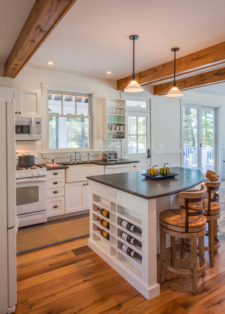 triangle kitchen island in farmhouse space with black countertop