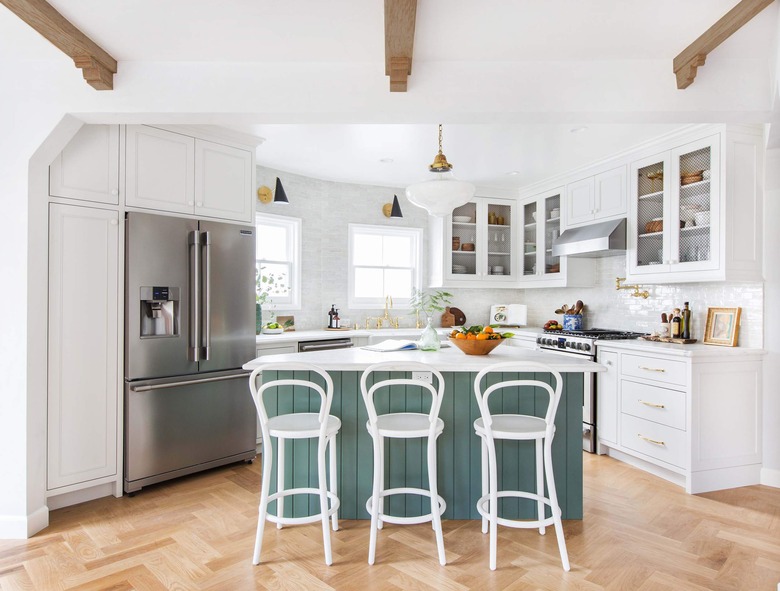 triangle kitchen island in modern white space with white countertops