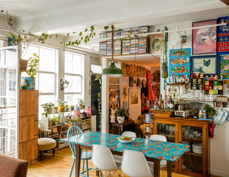 eclectic dining room with vintage green pendant light and antique wood furniture